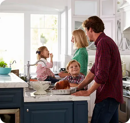 Family in a kitchen after selling their home